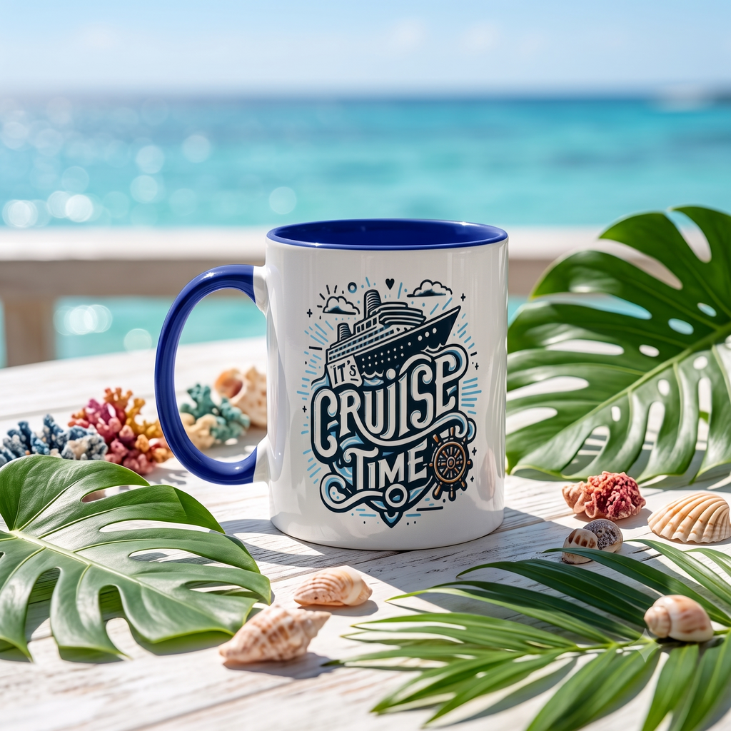 A white ceramic mug with a blue handle and interior, featuring a nautical 'CRUISE TIME' graphic, styled on a white wooden table with tropical leaves and seashells, with a blurred ocean background.